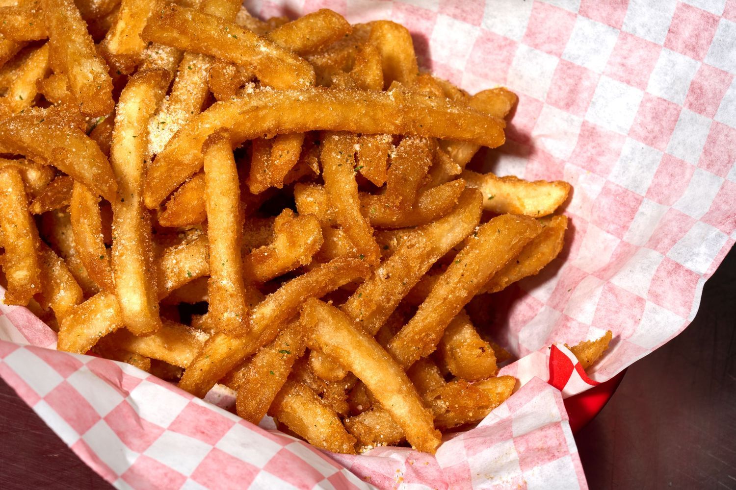 Seasoned fries in restaurant basket, photographed for fast-casual menu photography and promotional use.