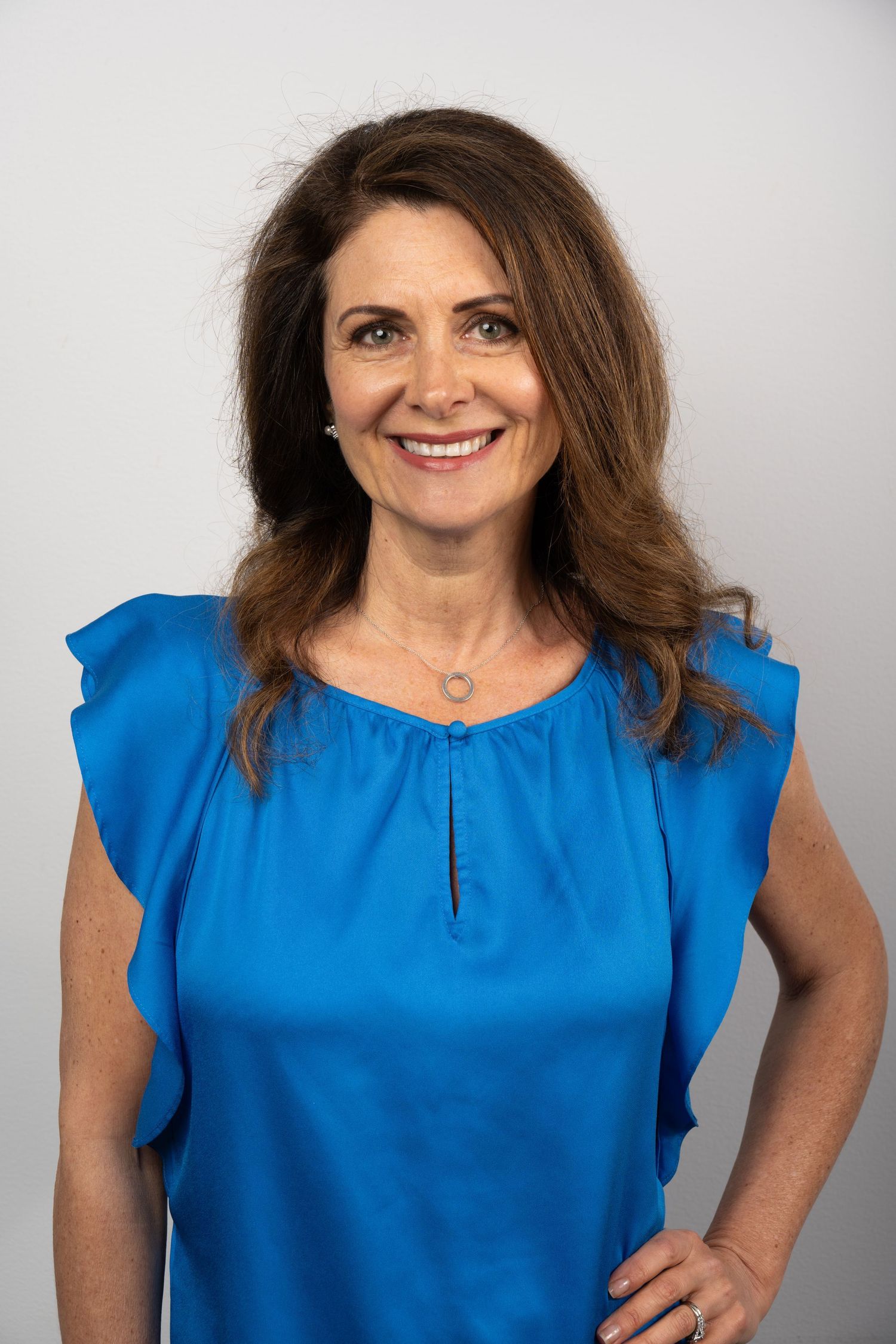 Business portrait with vibrant wardrobe and crisp lighting. Confident, clear, and leadership-focused.