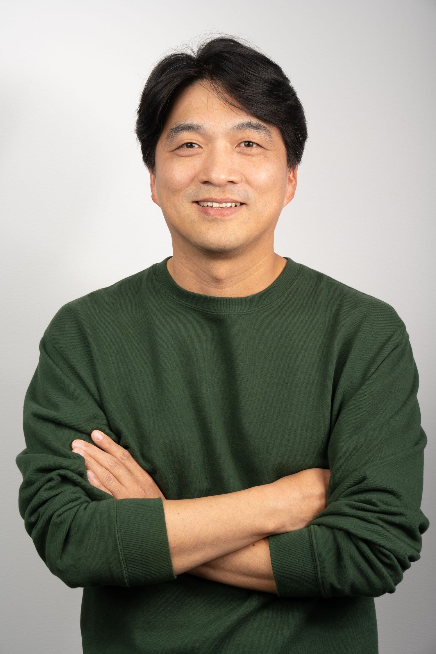 Contemporary headshot with relaxed smile and neutral background. Professional and approachable.