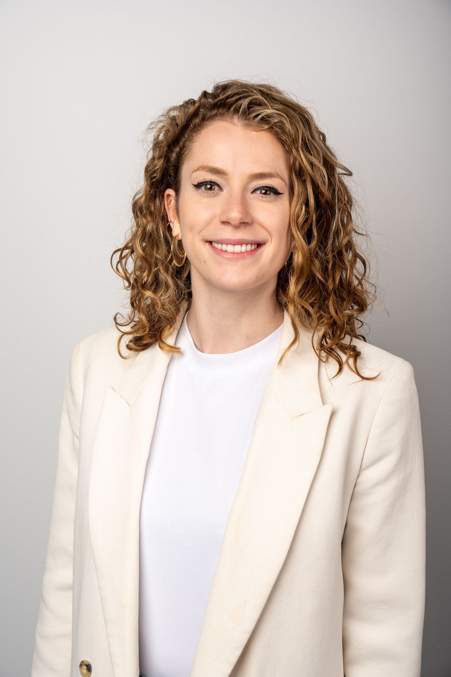 Modern studio headshot on clean white background. Polished, friendly, and ideal for personal branding.