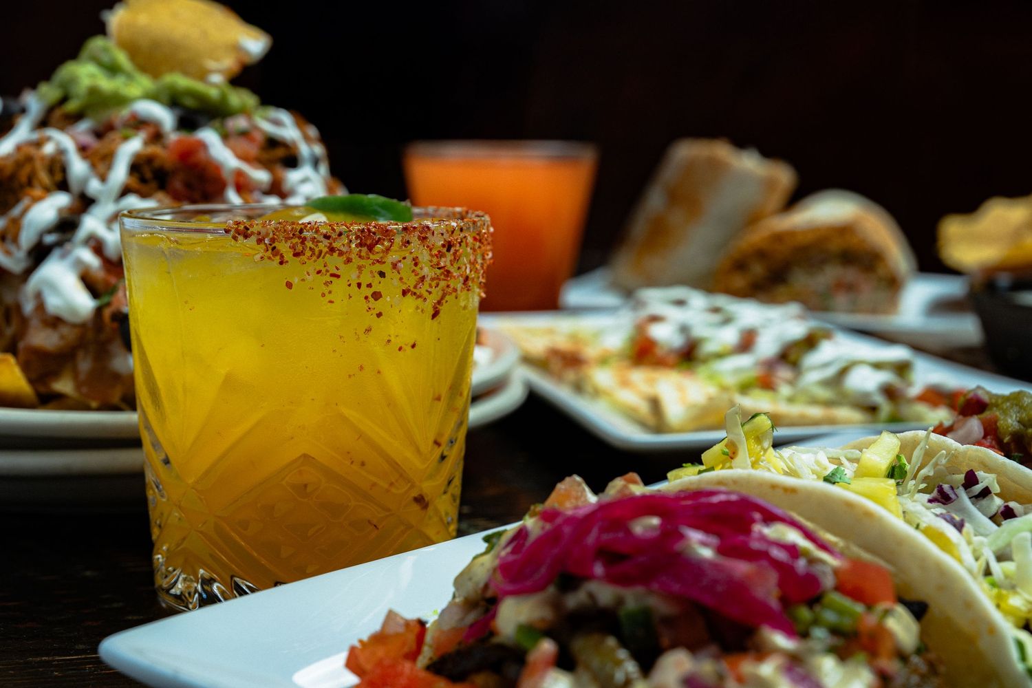 Cocktail with tacos and shared plates, photographed for restaurant menu, advertising, and social media.