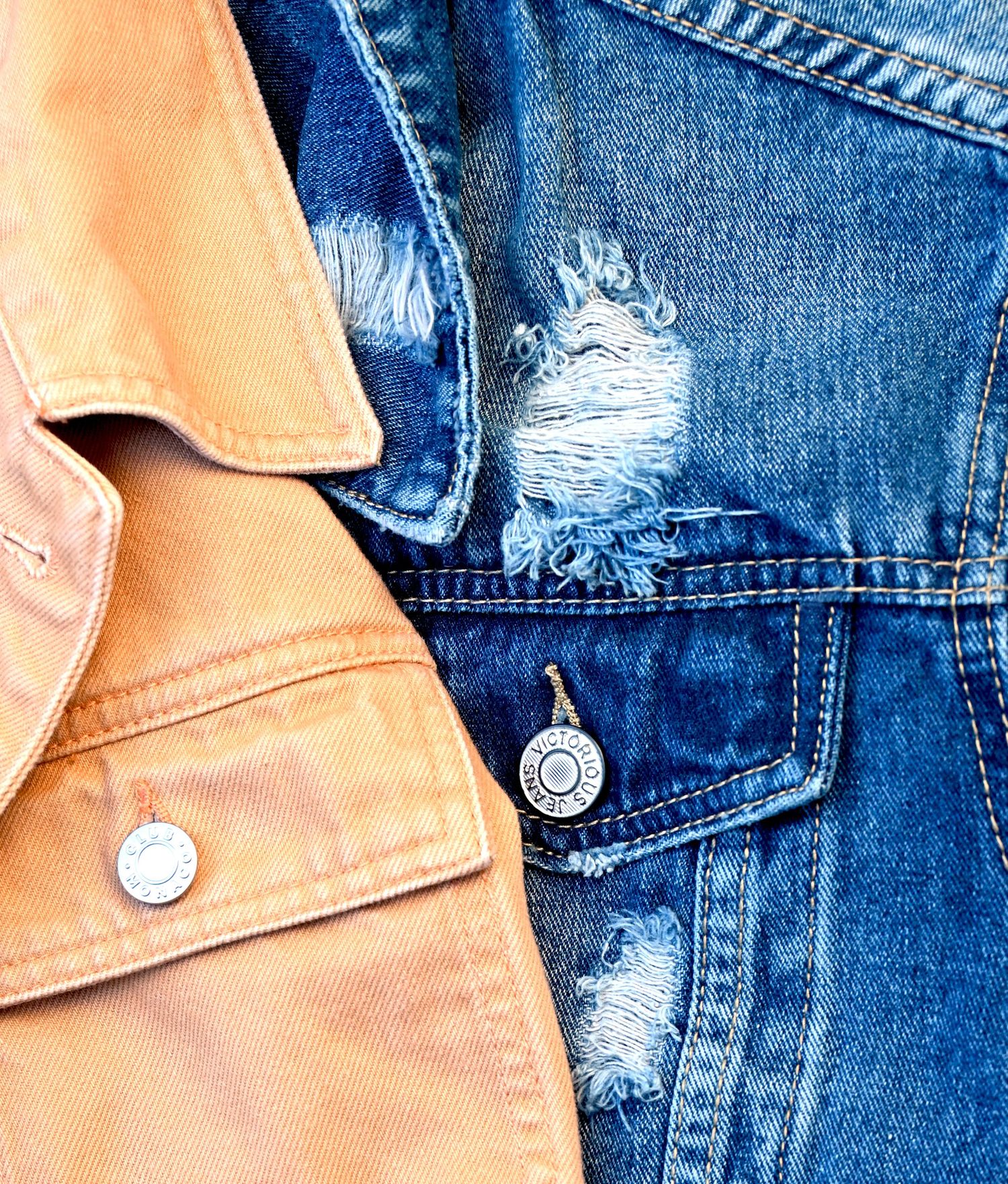 Denim jacket fabric and metal button details photographed for apparel branding and fashion product photography.
