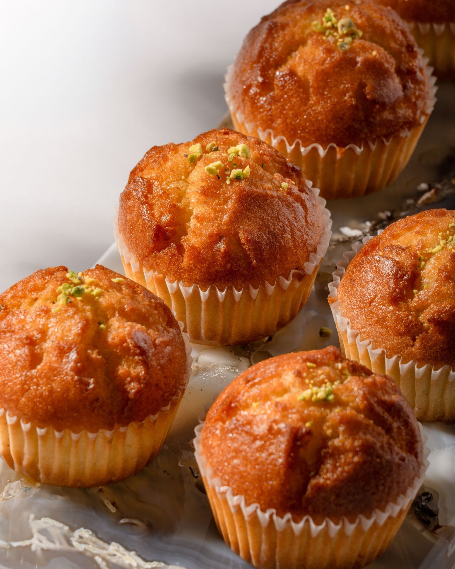 Pistachio Persian muffins photographed for bakery menu, packaging, and commercial food photography.