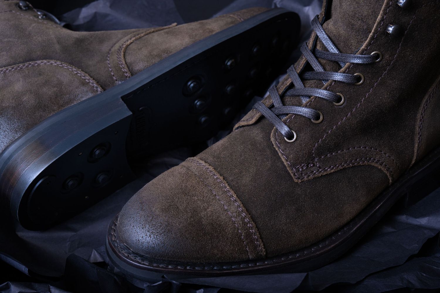 Suede leather boots photographed with dramatic lighting for footwear branding and e-commerce product use.