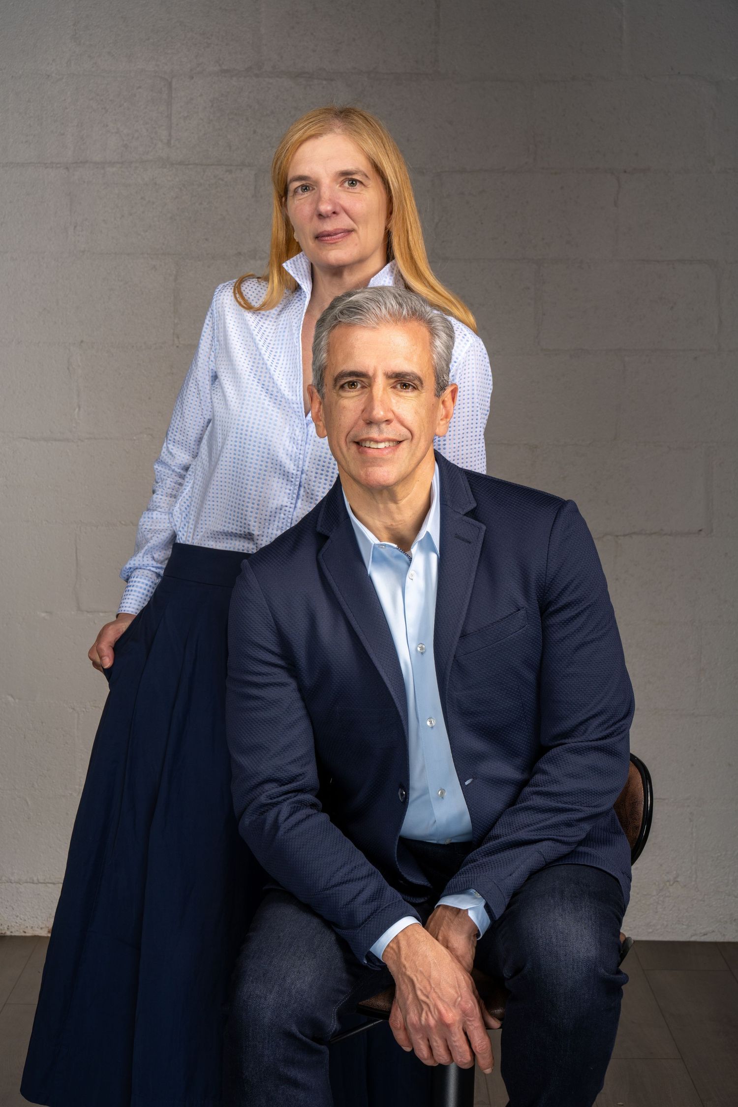 Professional duo portrait with balanced composition and subtle lighting. Warm, credible, and corporate-ready.