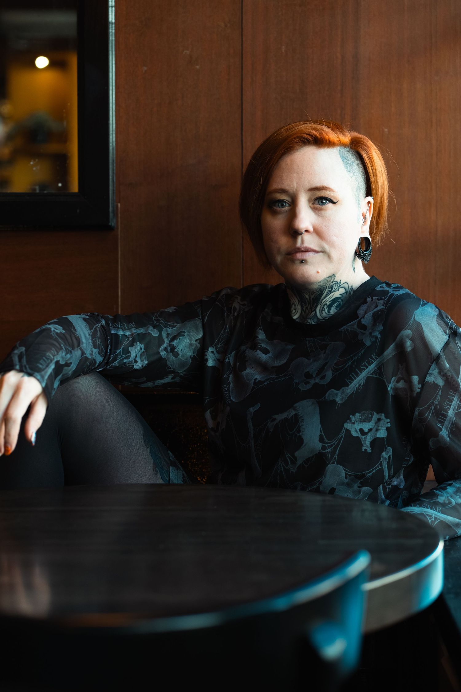 Moody environmental portrait with cinematic light and rich wood tones. Bold, expressive, and character-driven.