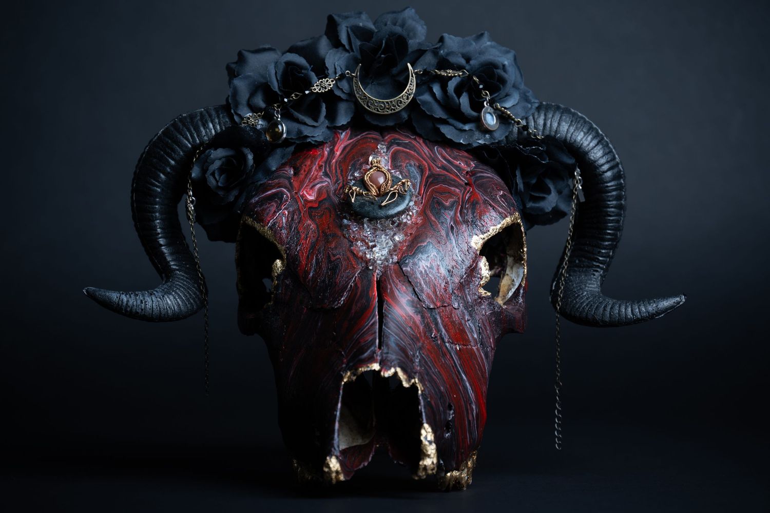 Handcrafted horned skull art piece styled with jewelry, photographed for luxury product and conceptual branding.