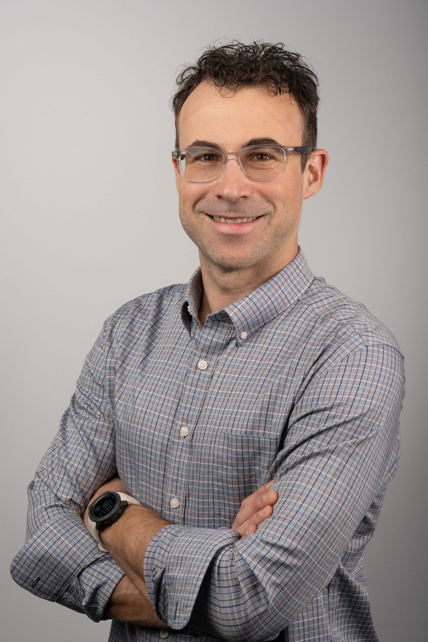 Contemporary headshot with relaxed smile and neutral background. Professional and approachable.