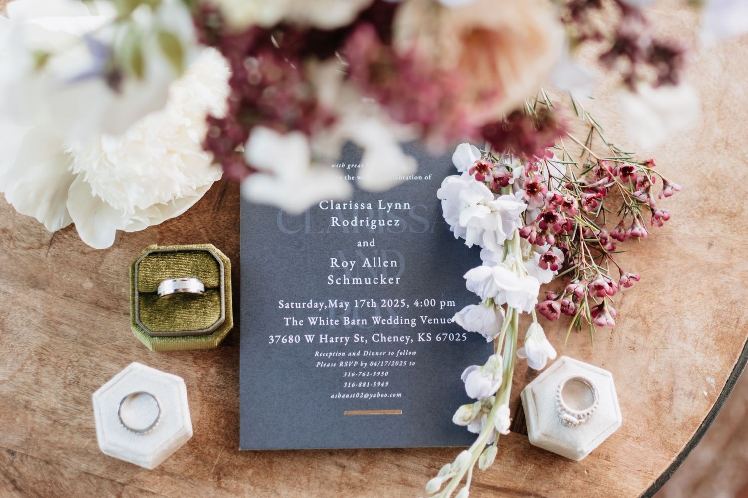 Wedding invitation details with delicate pink flowers and gray stationery.