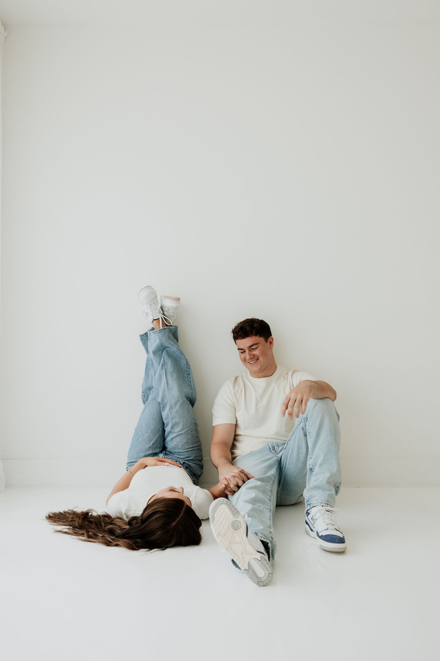 A casual lifestyle photoshoot featuring relaxed poses against a minimalist white background.