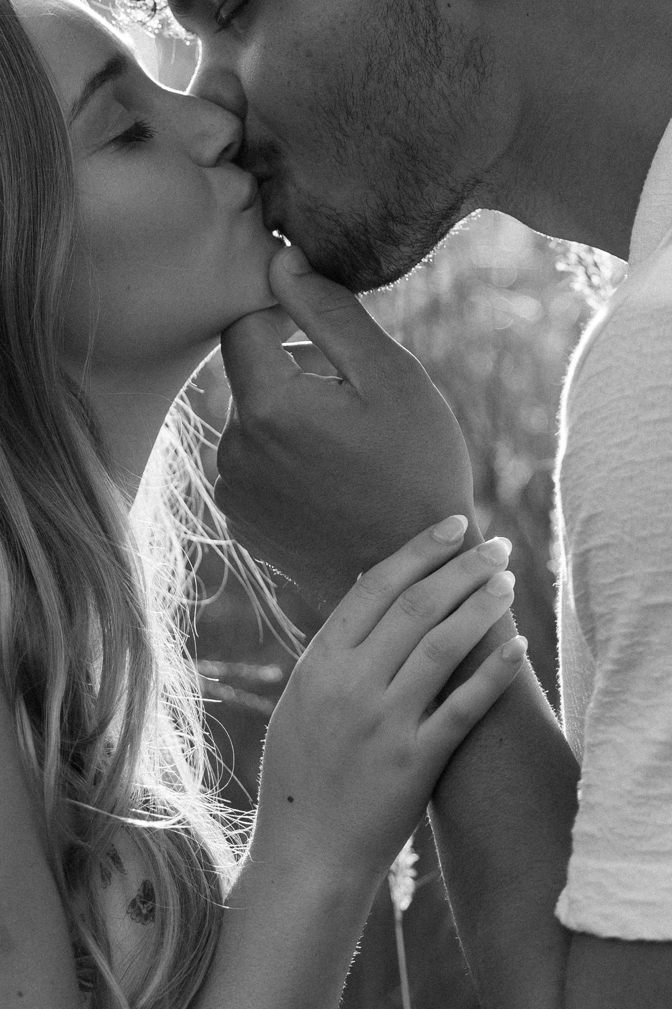 Black and white intimate close-up of couple sharing tender moment.