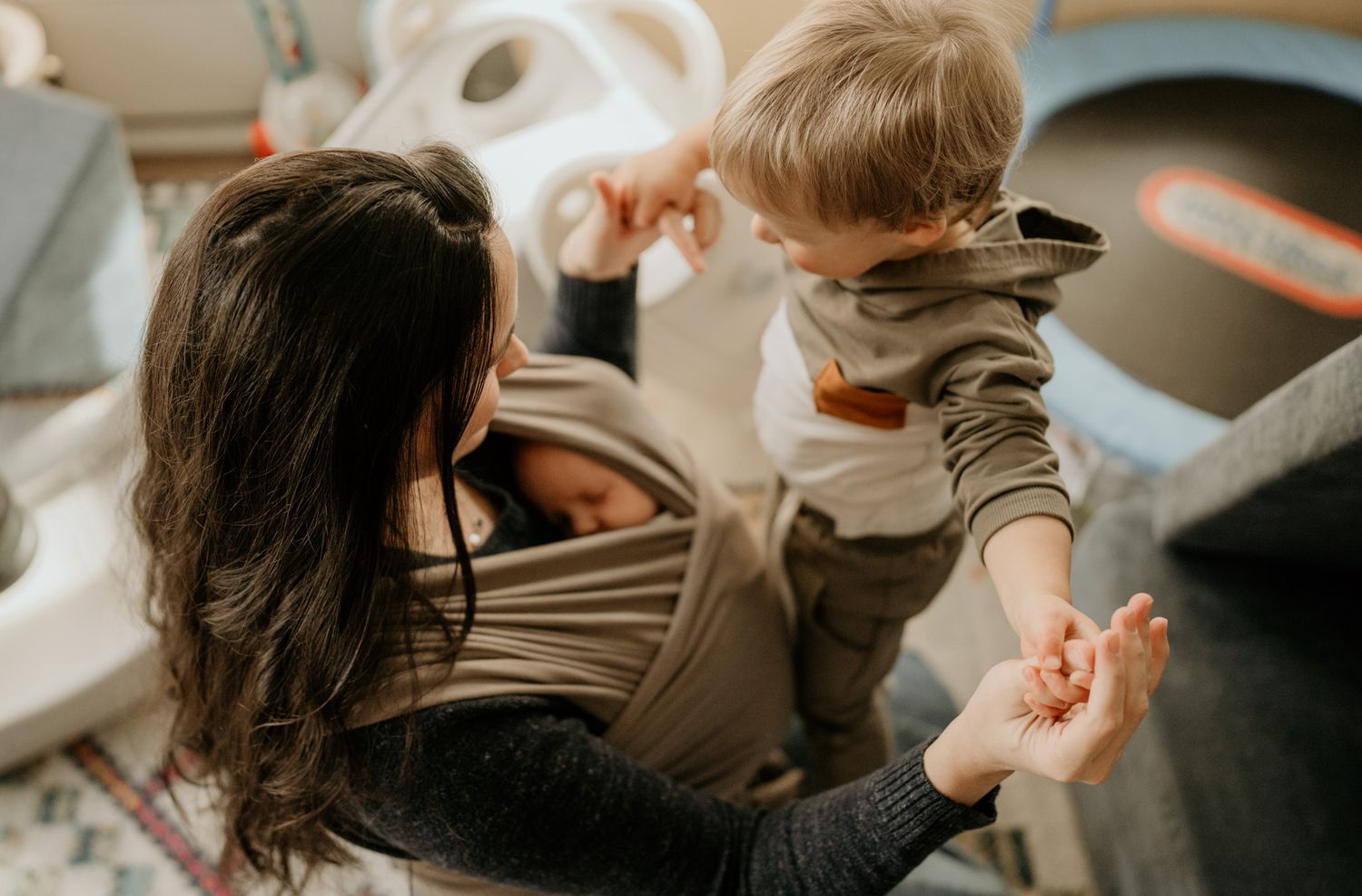 Close-up view of mother and son holding hands and playing together.