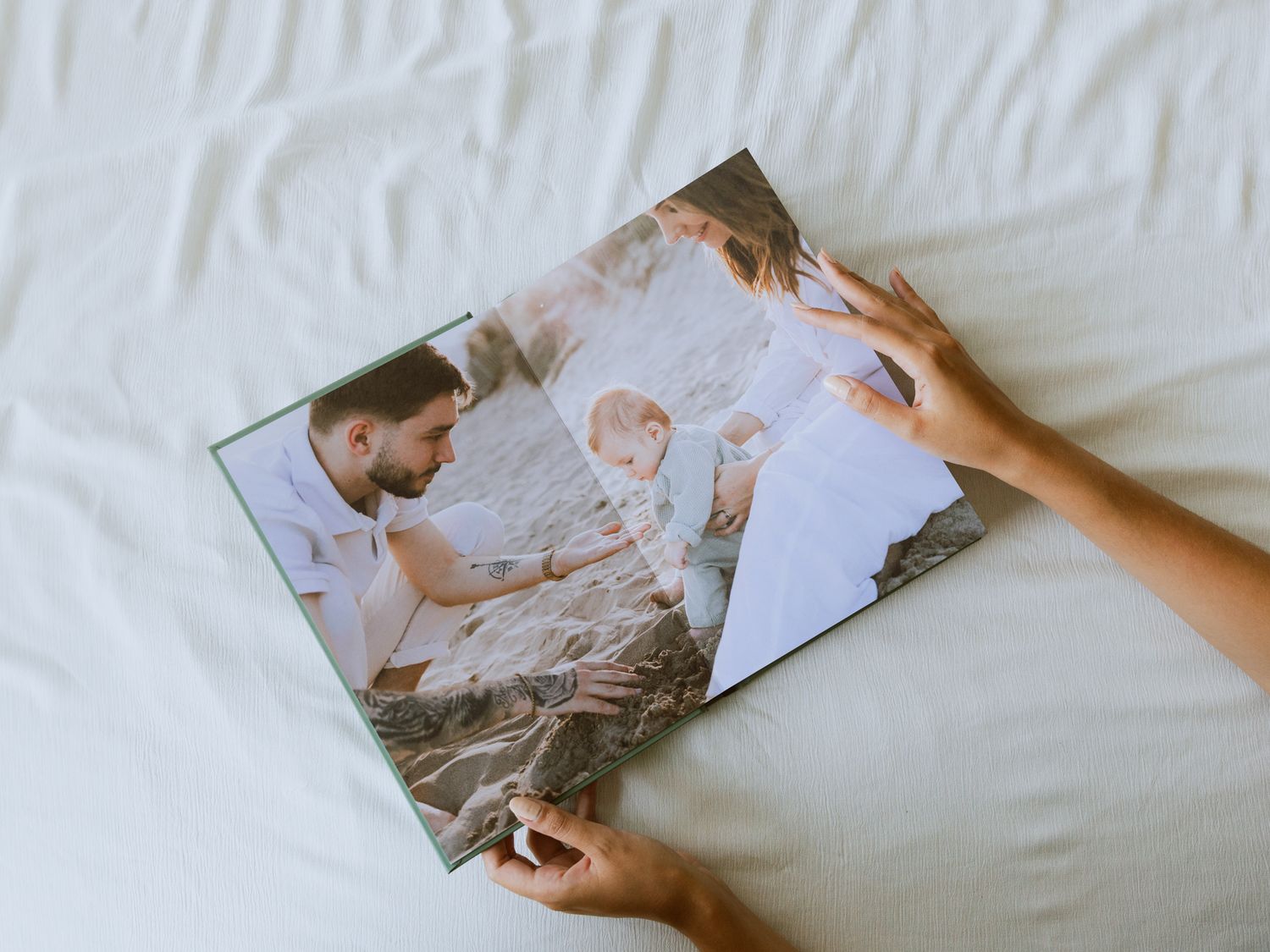 Des mains tiennent un album photo de famille professionnel personnalisé.