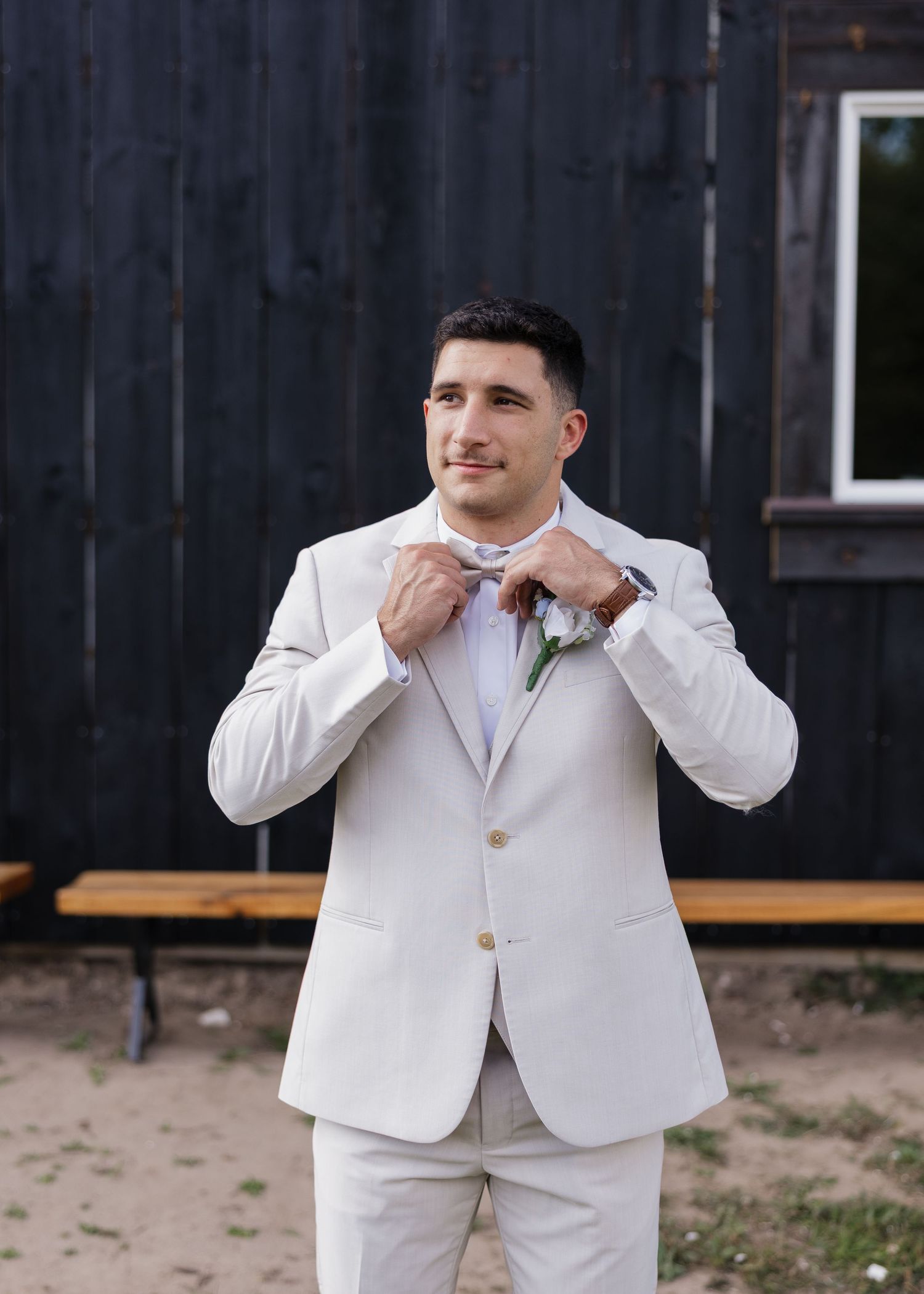 Series of photos showing groomsmen in white suits making silly expressions.