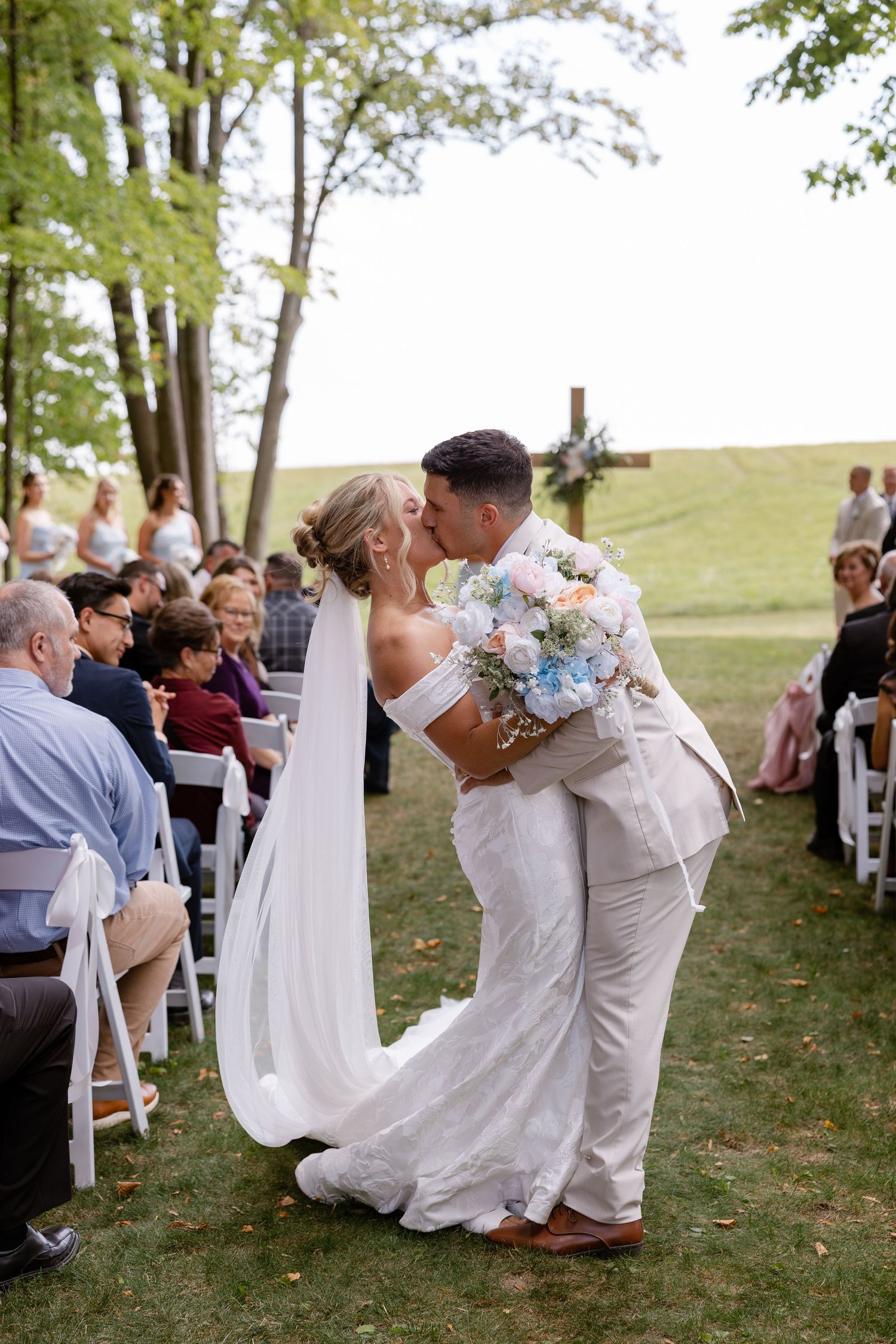 Newlyweds share romantic dance moves during their outdoor wedding celebration.