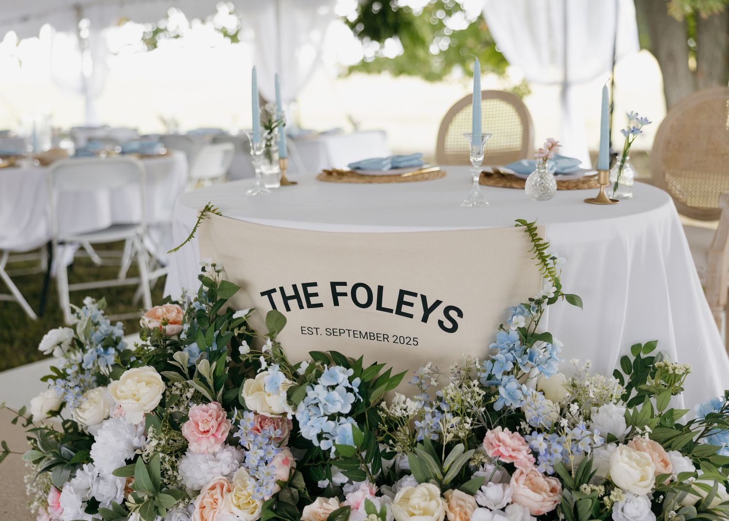 Elegant wedding reception tables decorated with white linens and floral centerpieces.