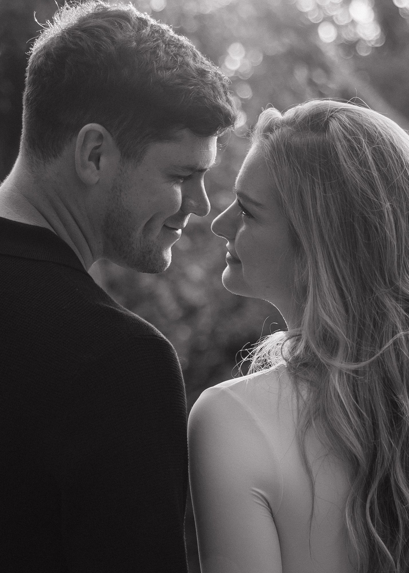Romantic black and white portrait series of couple in intimate close-up poses.
