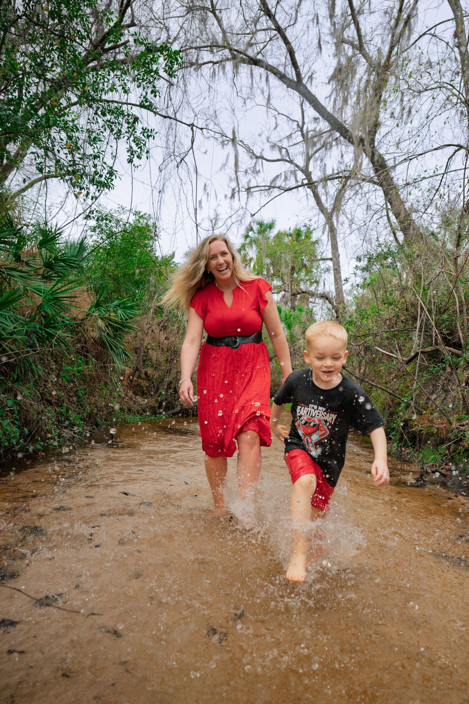 A sequence of photos shows people splashing and playing in a muddy puddle on a wooded trail.