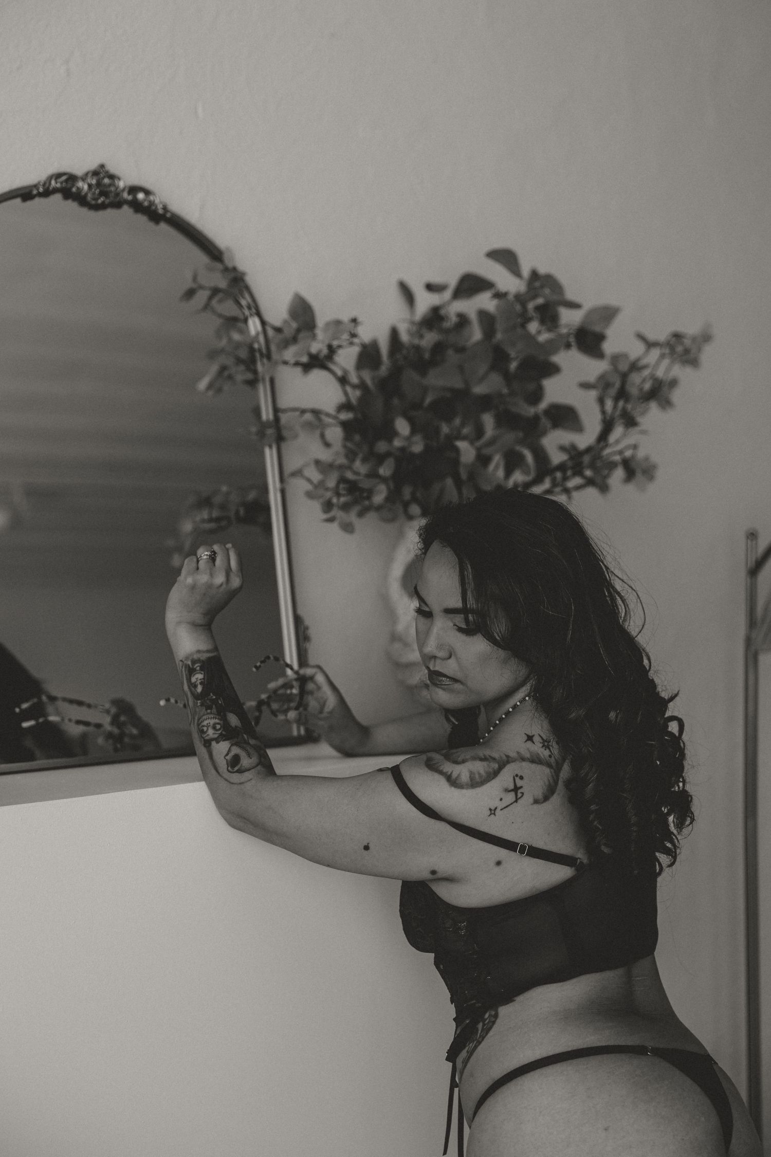 Black and white boudoir portrait with tattoos and lingerie by Nashville and Clarksville boudoir photographer. subtle light and airy modest