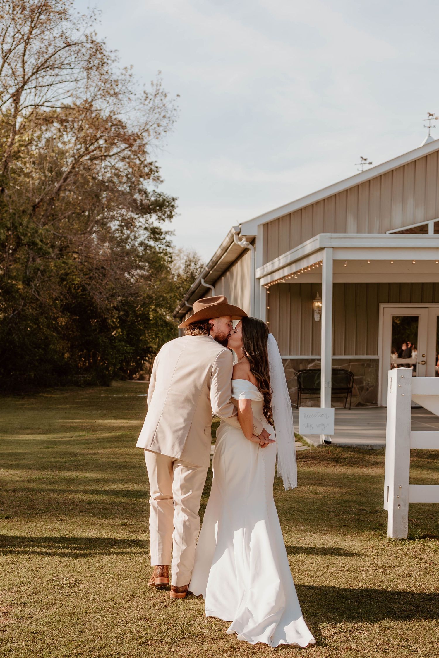 Southern-inspired wedding portrait featuring a groom in a cowboy hat and his bride nashville wedding photographer
