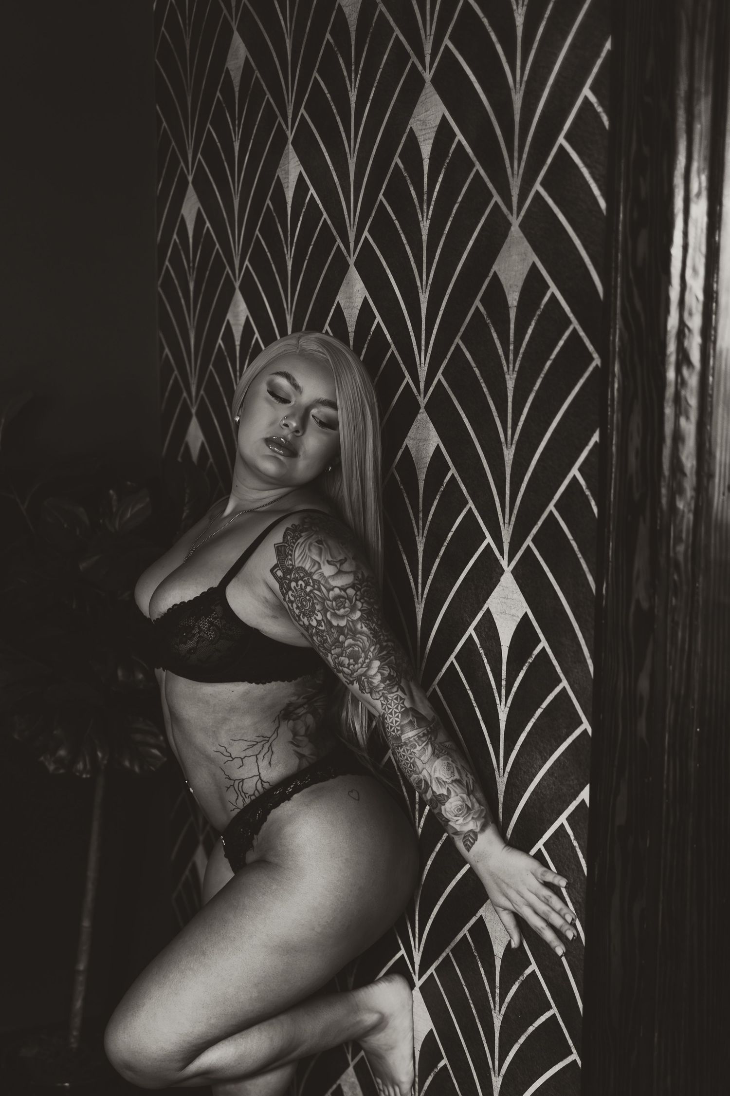 Black and white boudoir portrait with tattoos and lace lingerie by Nashville and Clarksville boudoir photographer.