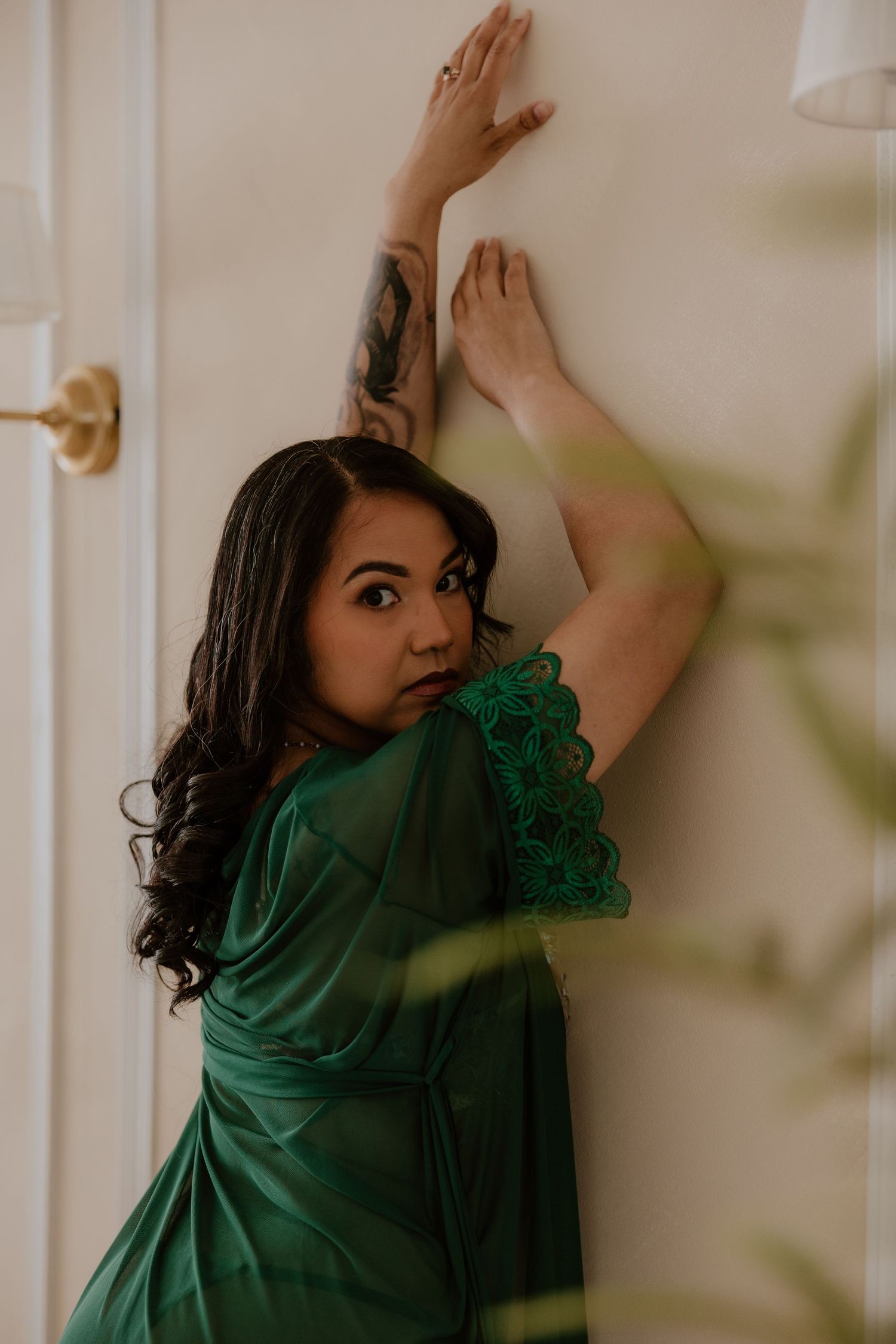 Luxury boudoir photography featuring elegant posing and emerald lingerie styling in Tennessee. warm tones light feminine beautiful intimate