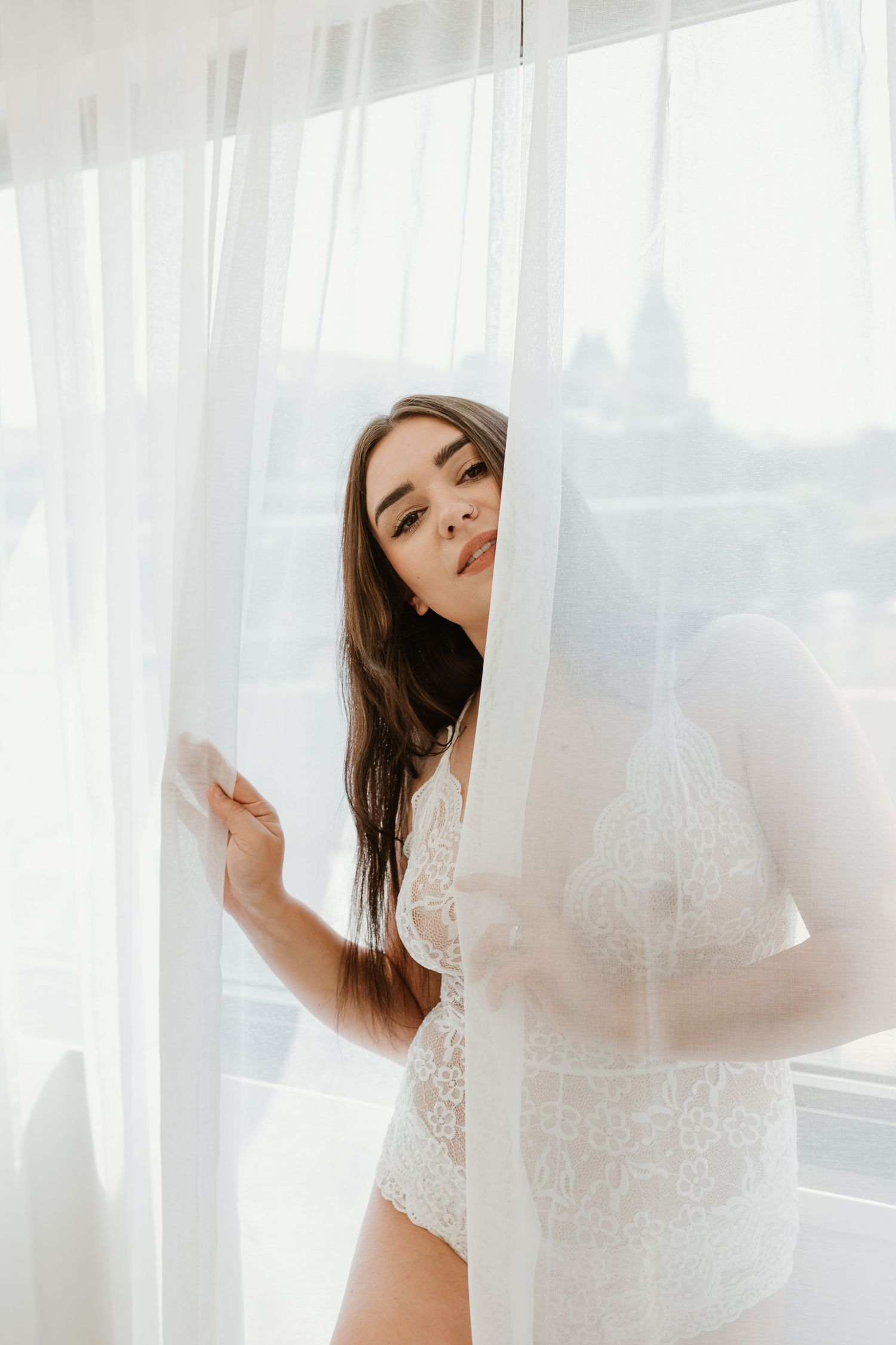 Light and airy boudoir photography featuring soft posing and white lace lingerie in Middle Tennessee.