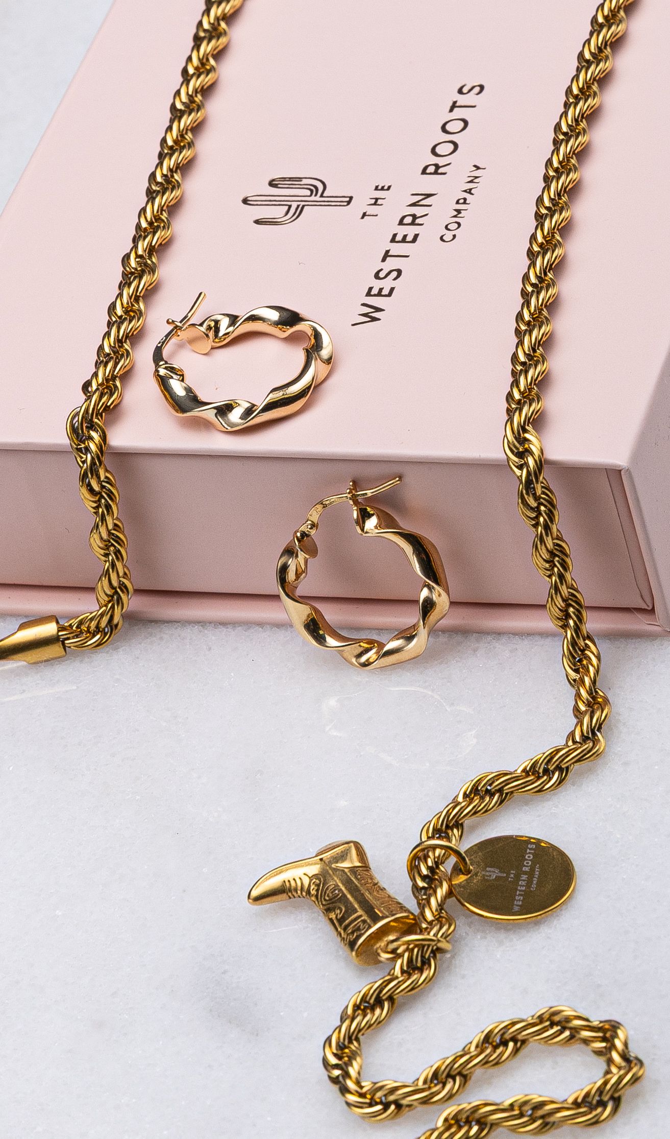 Gold rope chain necklace with twisted hoop earrings and cowboy boot charm by The Western Roots Company.