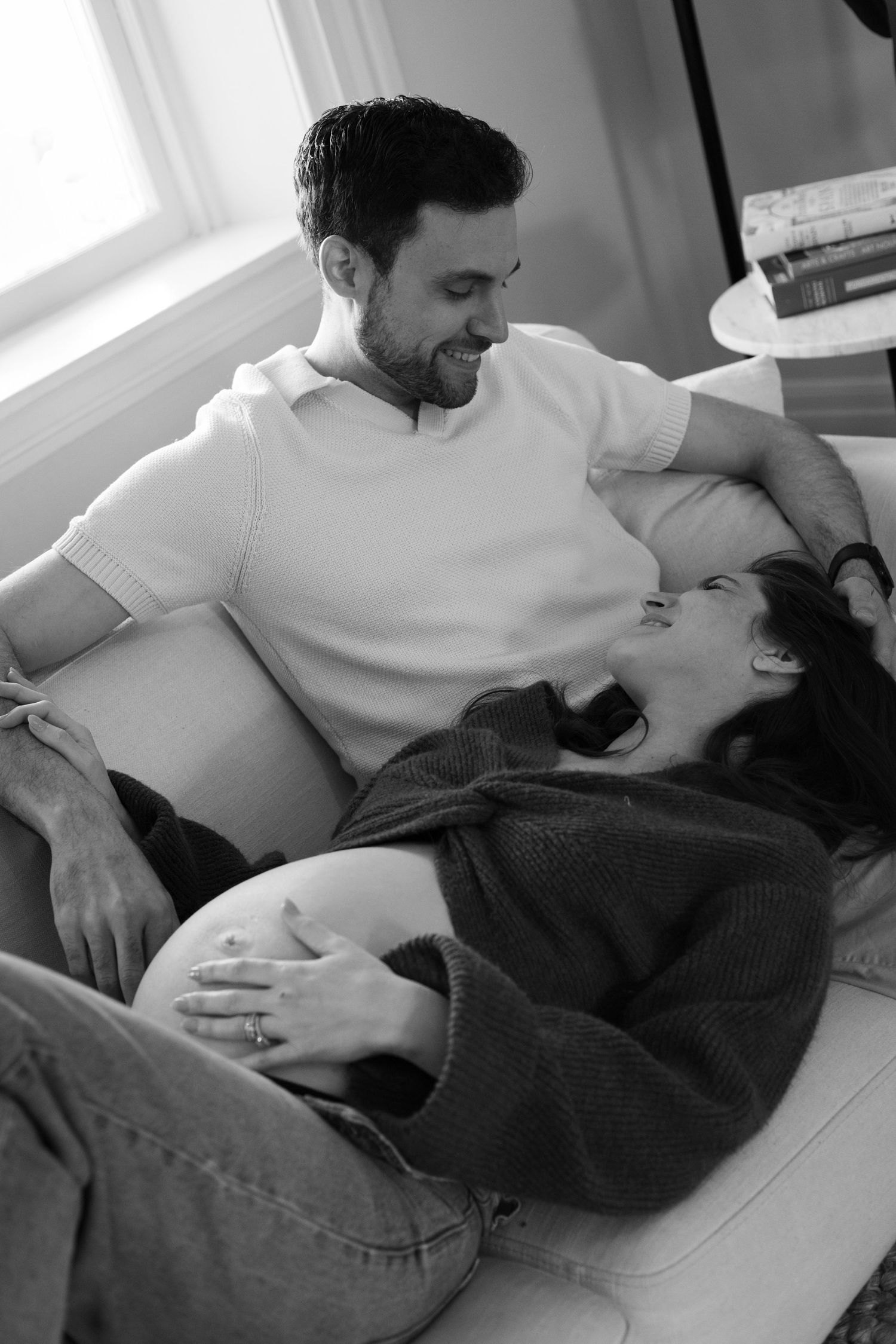 Couple laying on couch with mother hand on belly | Bijou-Marie d'Image | Richmond VA Photography