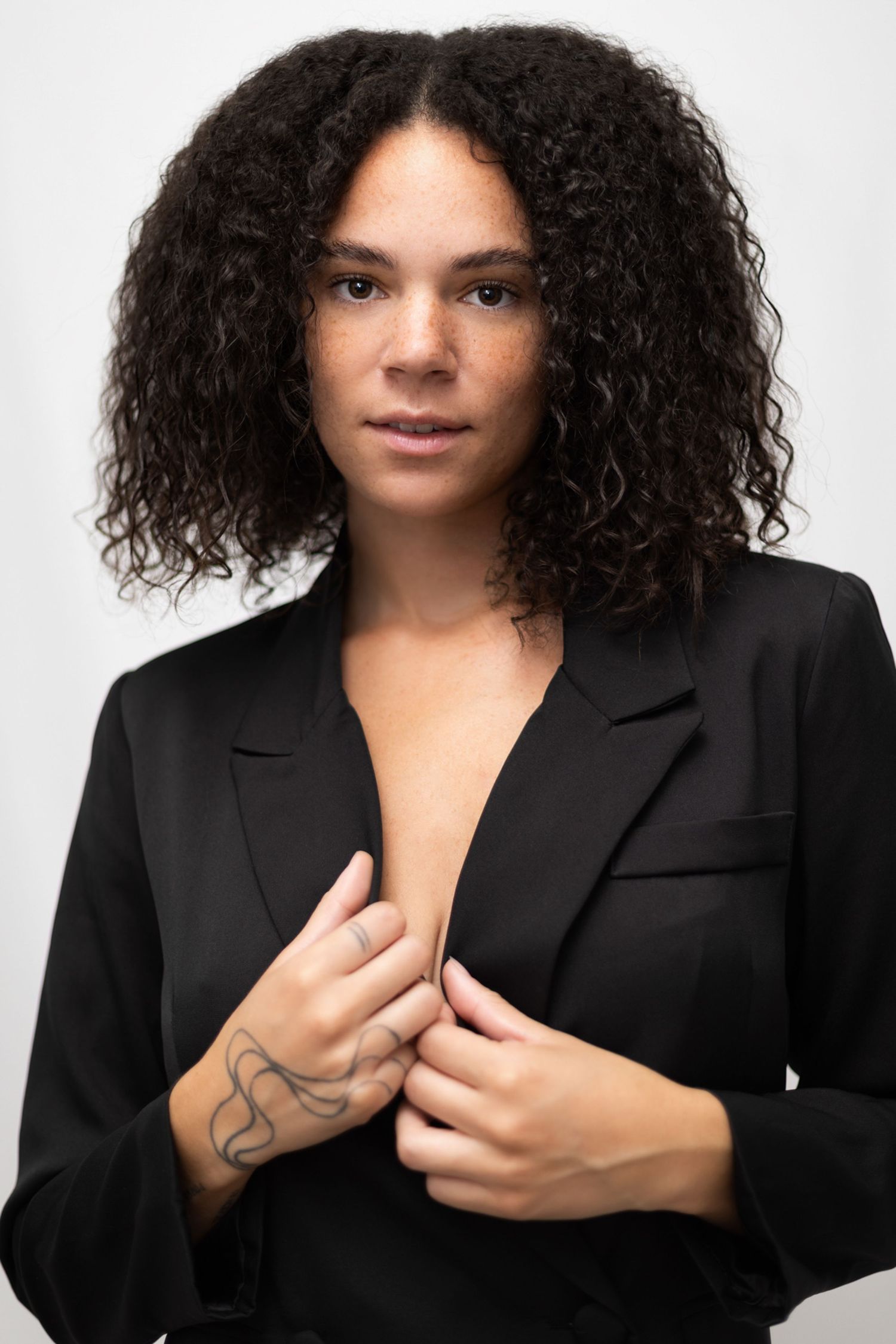 Curly woman holding her blazer