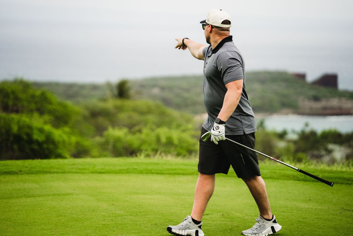 Photo of a golfer pointing to his ball at a golf course in Lanai Hawaii for a sales incentive trip captured by Fantasma Imagery