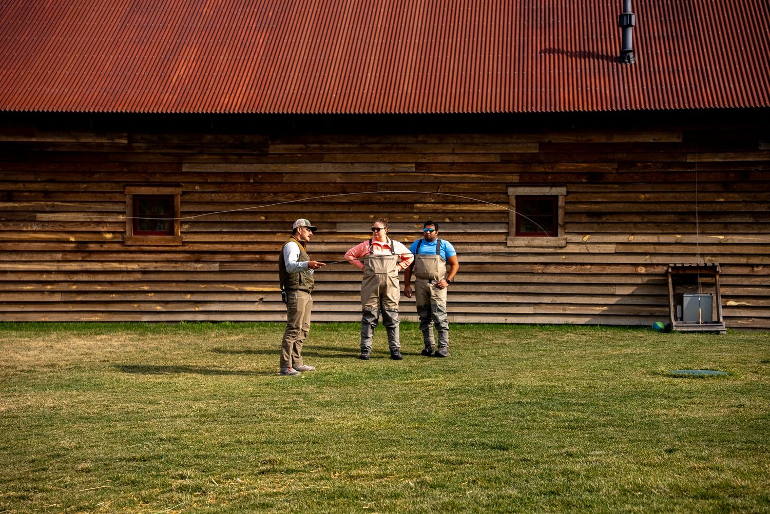 Fisherman teaching 2 people how to cast a fly rod at The Ranch at Rock Creek in Montana.