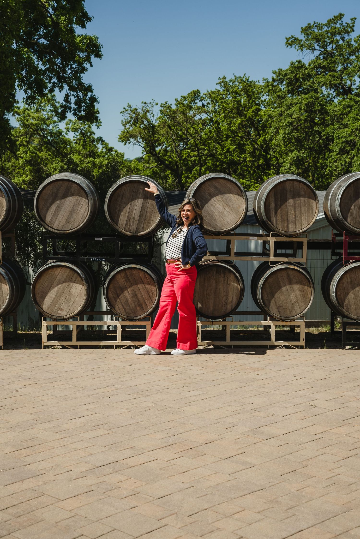 Woman posing in front of wine barrels at B.R. Chon winery
