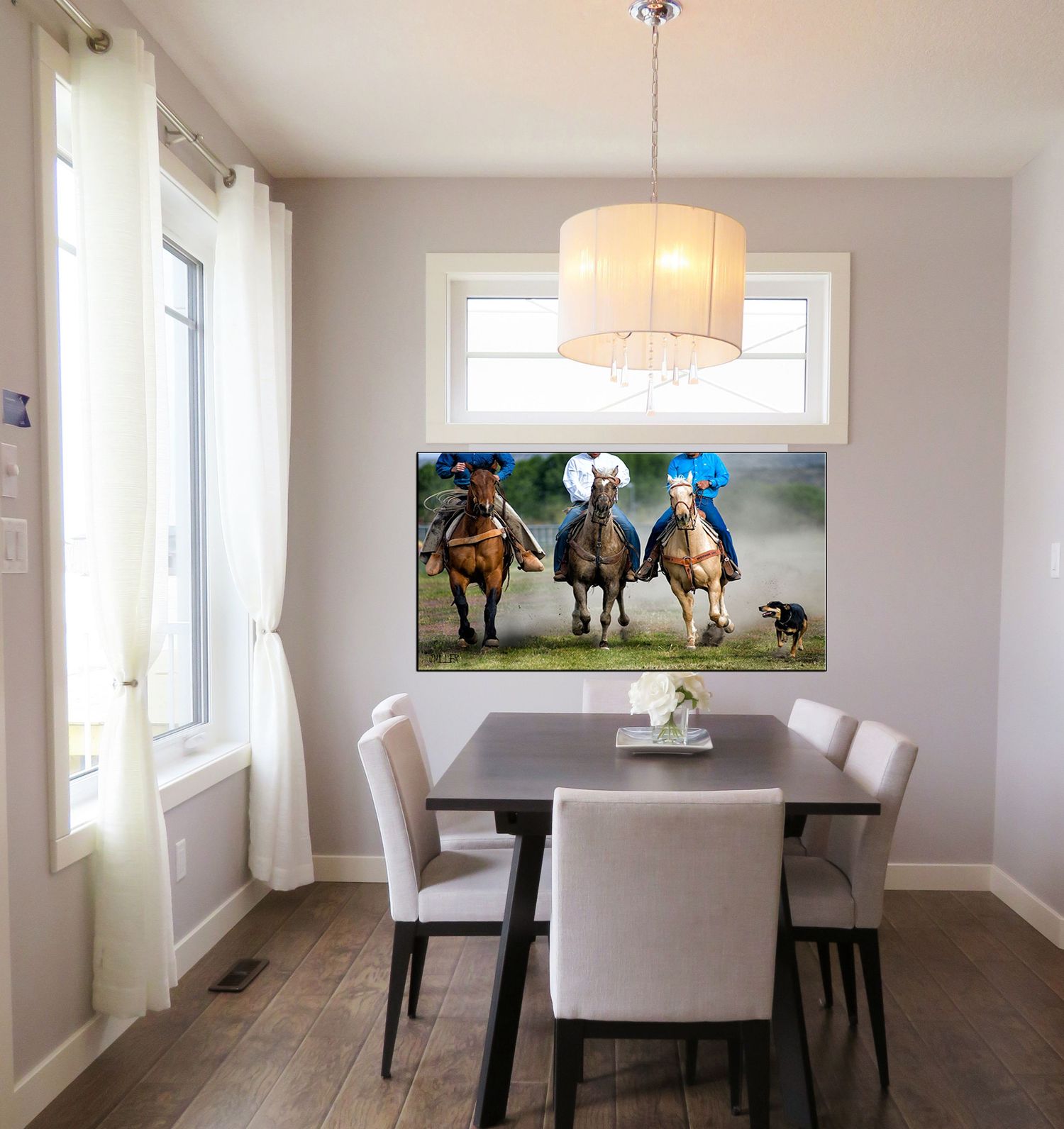 Modern dining room with dark wood table, white chairs, chandelier, and a large canvas print of three horses racing on the wall.