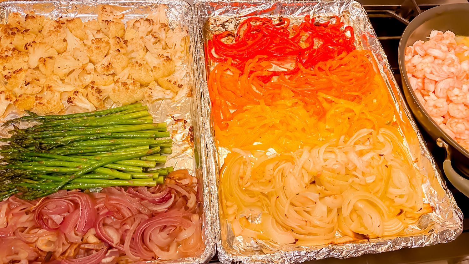 Assorted seafood ingredients displayed in foil containers with garnishes.