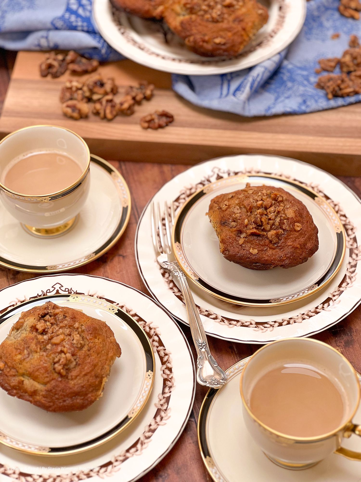 Rustic cookies served on decorative plates with teacups and blue linens.
