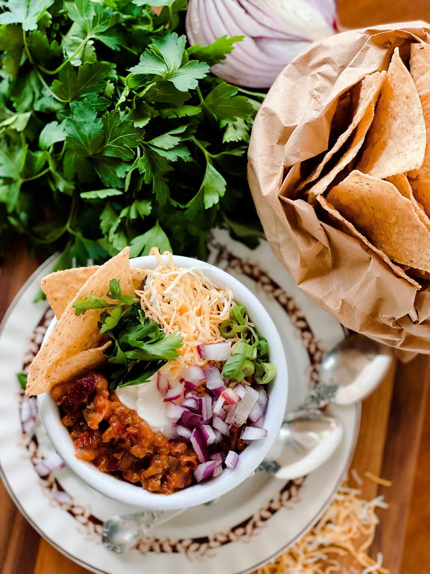 Taco filling garnished with fresh herbs and red onions served in decorative bowls.