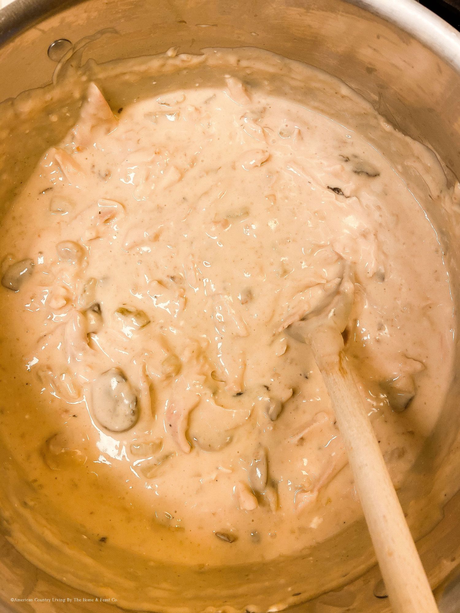 Creamy mushroom sauce cooking in a large skillet.