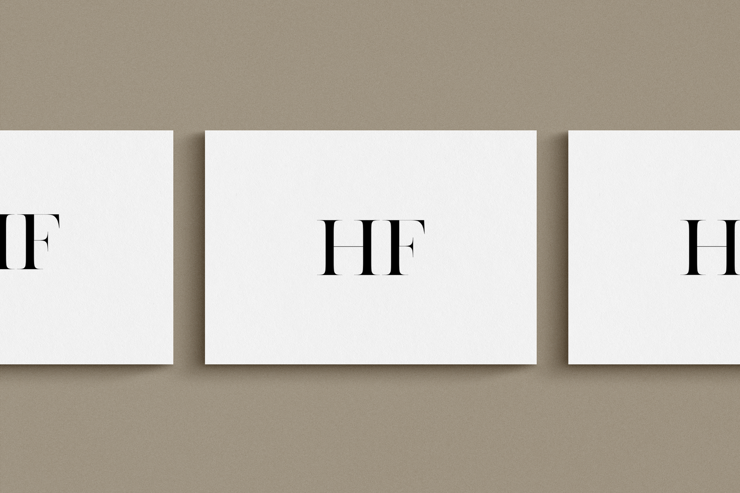 Three white rectangular cards displaying elegant HF monogram initials in serif font on taupe background.