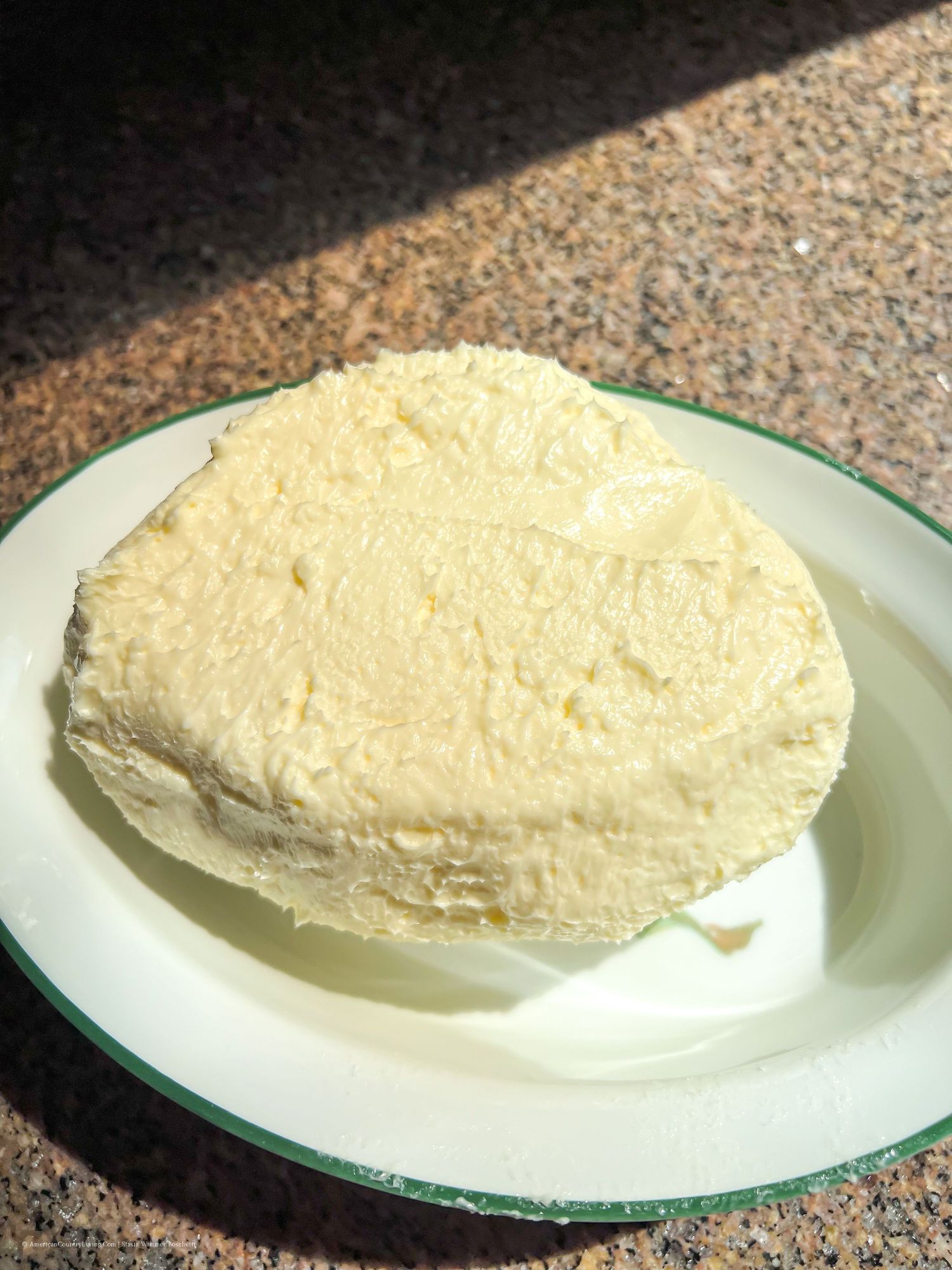 White ricotta cheese spread on a round glass plate.