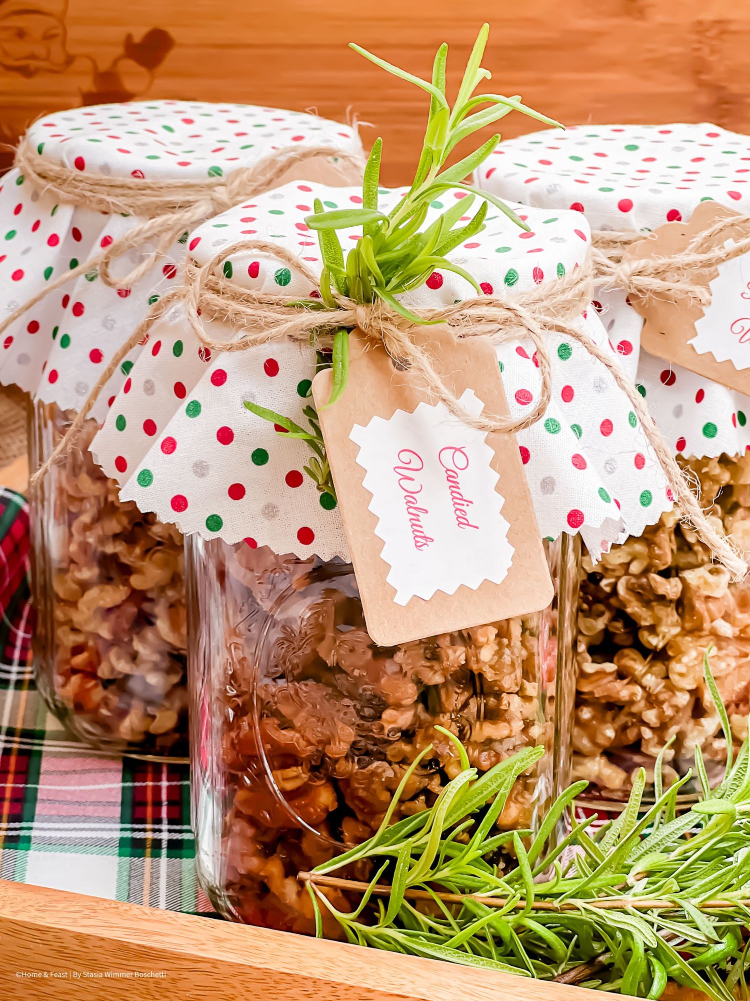 Holiday-themed mason jars filled with homemade granola and topped with polka dot fabric covers.