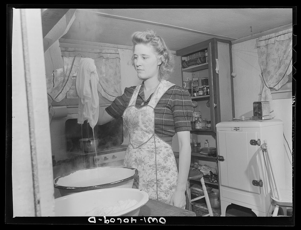 A series of vintage black and white photographs showing people camping and setting up outdoor shelters in a rural setting.
