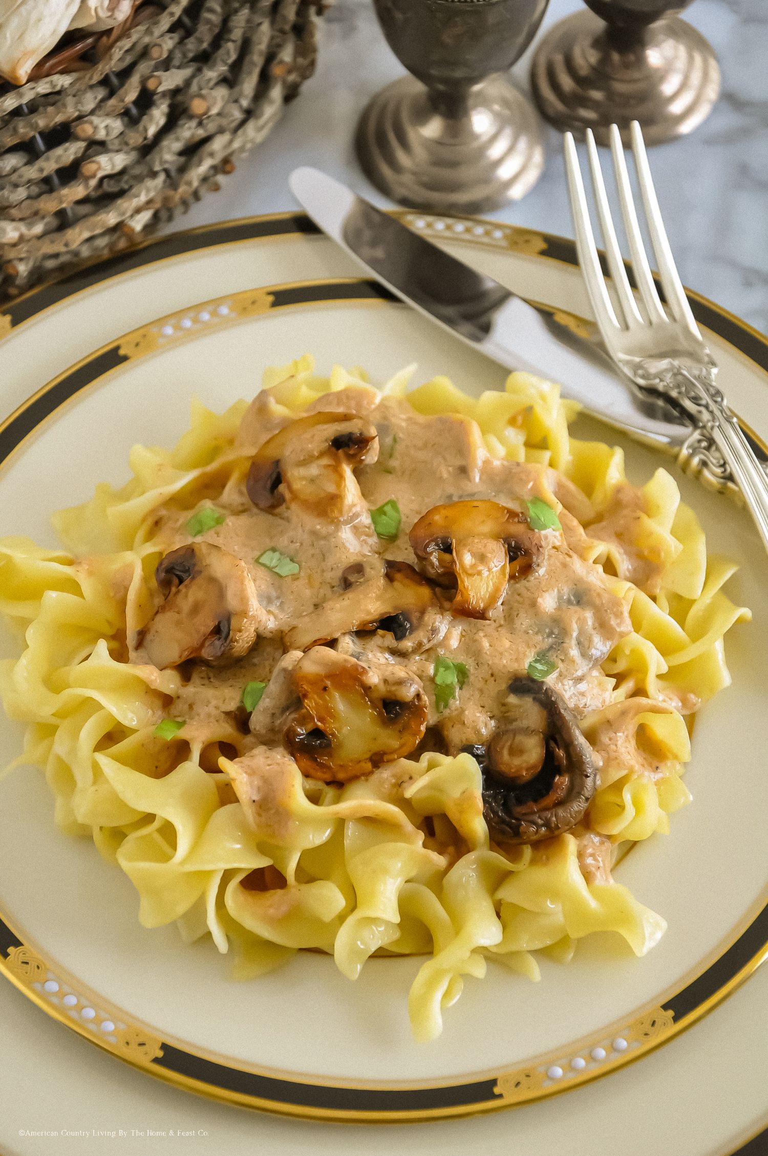 Elegant beef stroganoff with mushrooms and green onions served over egg noodles.