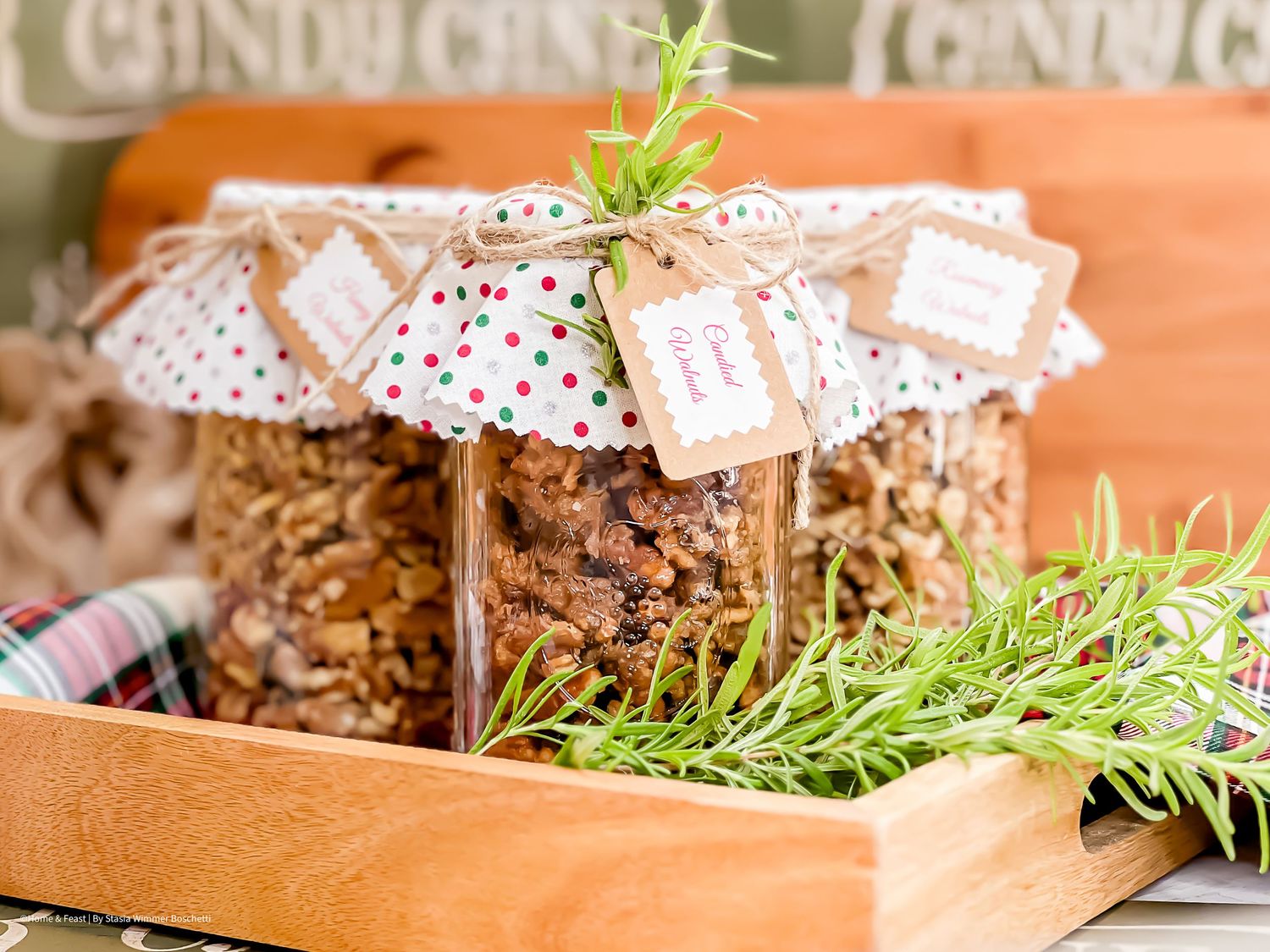 Gift-wrapped mason jars of granola with festive polka dot covers and fresh herbs.
