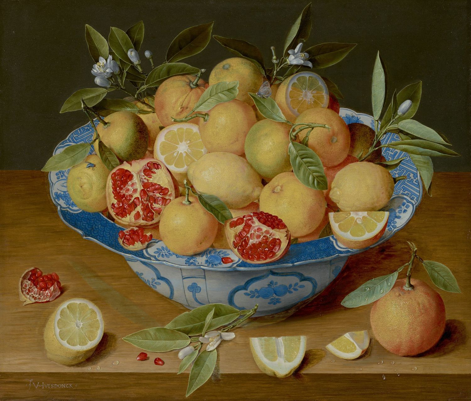 Dutch still life oil painting of lemons and pomegranates in a blue and white ceramic bowl on a wooden table.