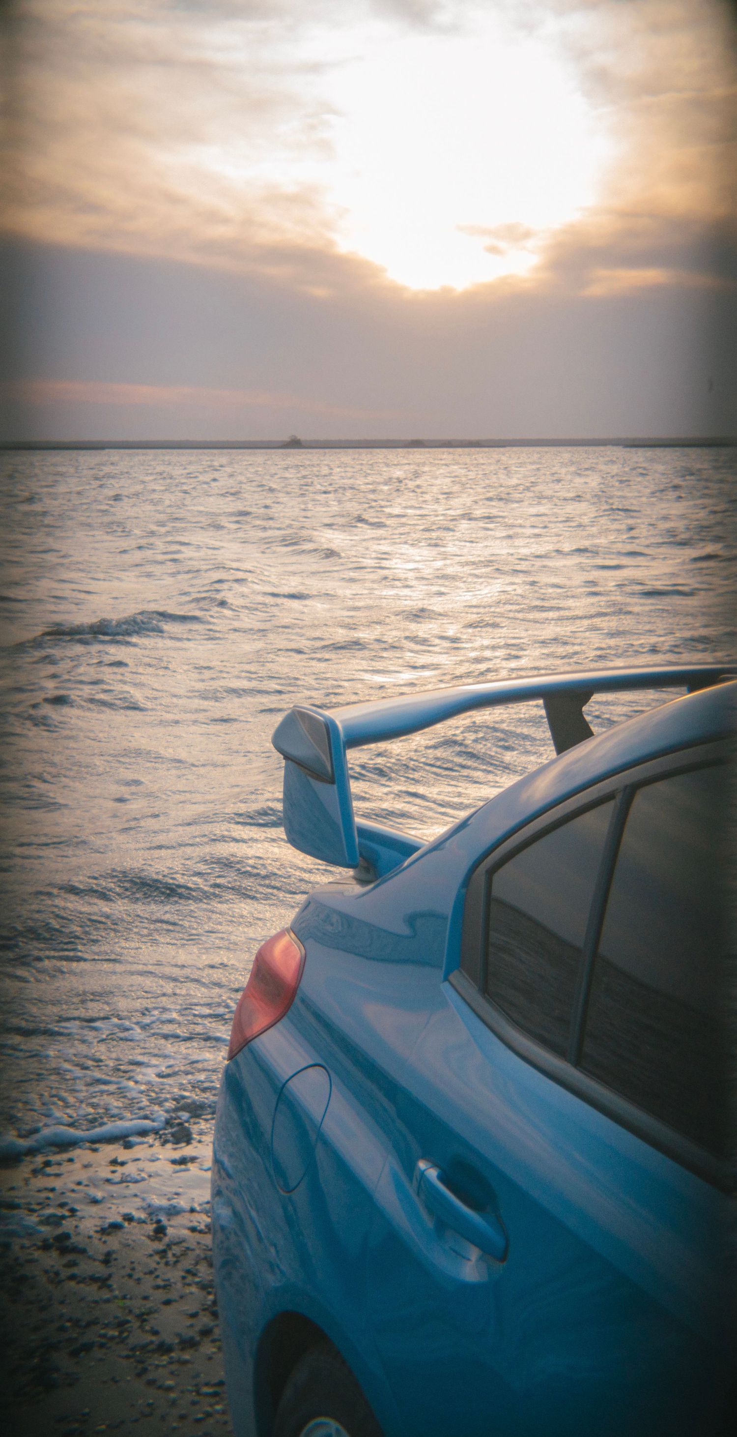Rear of a hyper blue STI with wing overlooking the bay in South Jersey near Ocean City