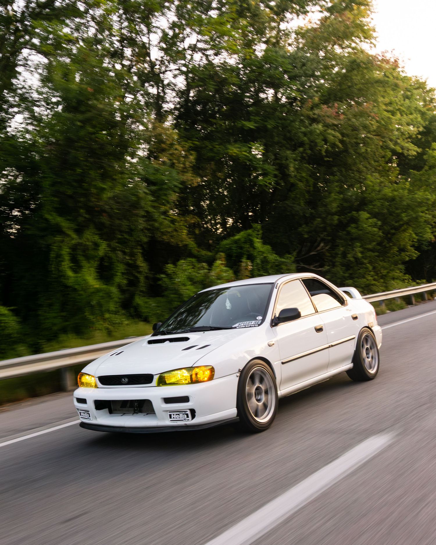 Subaru Impreza heading down a highway to boxer fest during sunrise