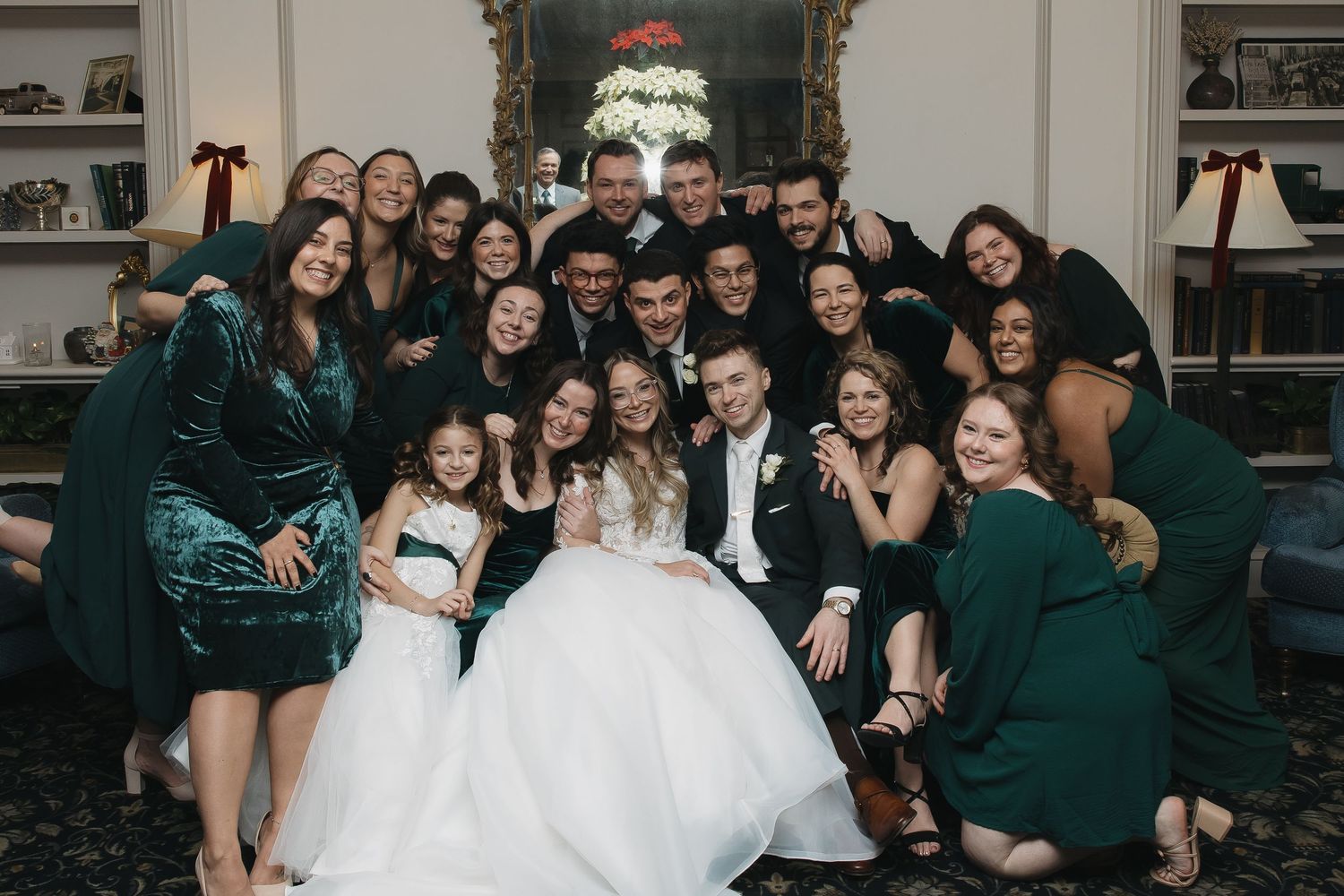 entire bridal party loving on the bride and groom