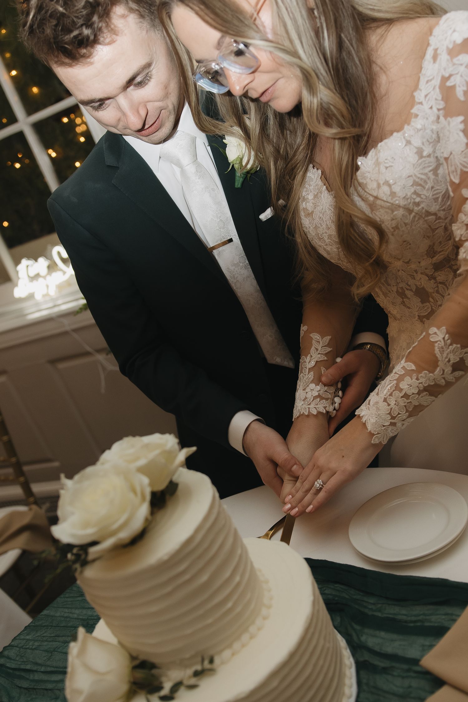 couple cutting cake at their wedding