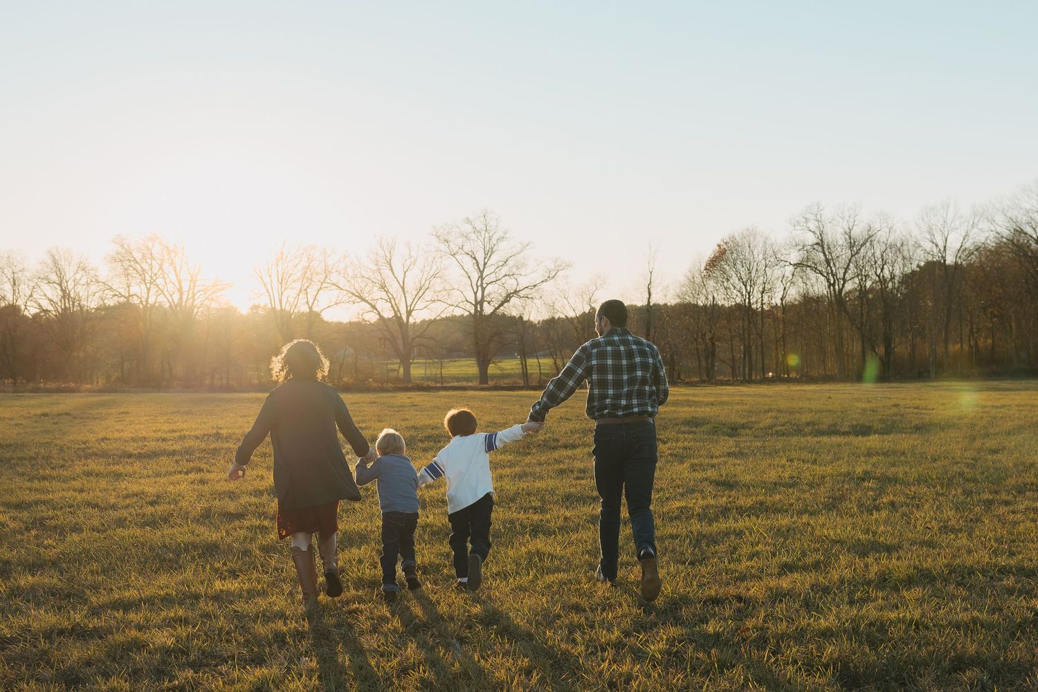 family running off holding hands